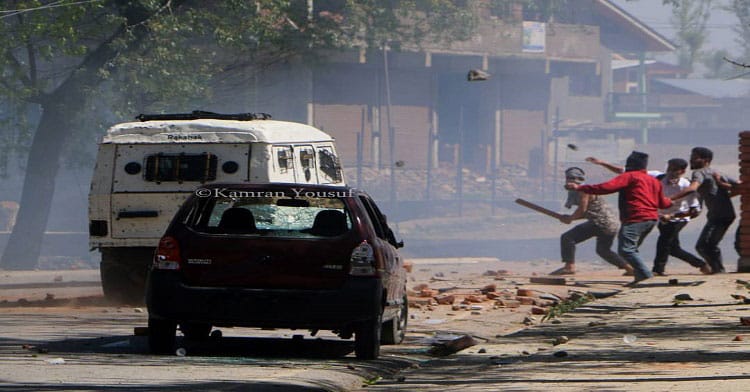 Youth pelting rocks on security forces after they resorted to tear shelling near Degree College Pulwama