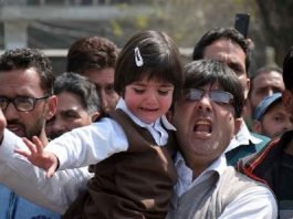 Assembled along their children, casual labourers protest in Srinagar
