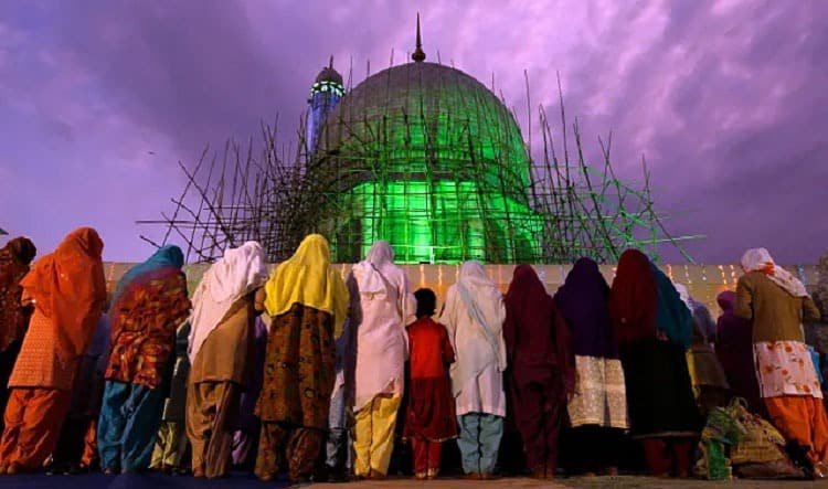 Muslim women perform evening prayers in the compound of Hazratbal shrine