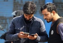 Cash crunch hits Kashmir as digital banking stalls amid internet curbs Youth accessing internet on their phones in Srinagar