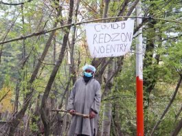 A man stands guard as his village was declared Red Zone in Pulwama