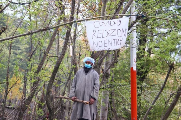 A man stands guard as his village was declared Red Zone in Pulwama