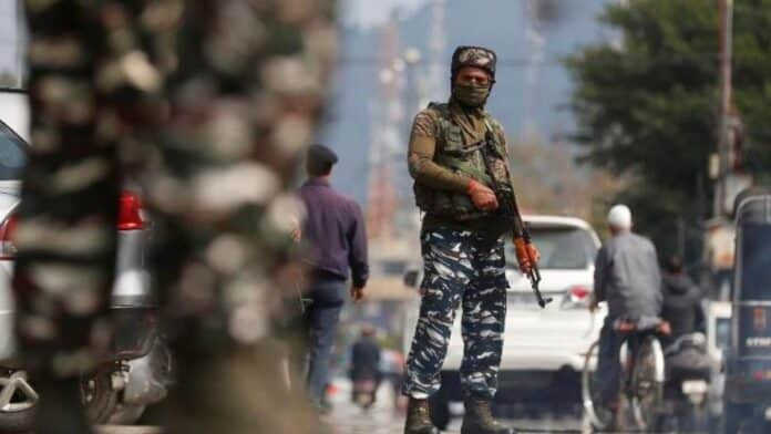 An Indian Army soldier stands guard on a Srinagar road