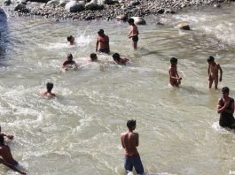 Children taking bath to beat the heat in a canal in south Kashmir's Pahalgam area