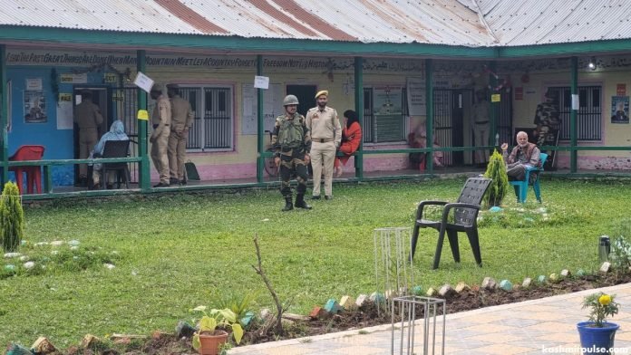 Security forces including J&K Police and CRPF stand guard at a polling station in Pinglena village of Pulwama Security forces including J&K Police and CRPF stand guard at a polling station in Pinglena village of Pulwama