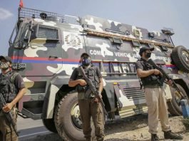 Crisis Response Team (CRT) stand near command vehicle of J&K Police in Jammu
