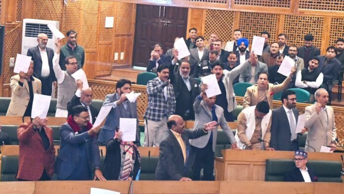 On first day of Business, NC leaders wave the 'special status' resolution towards opposition BJP after passed by the Speaker
