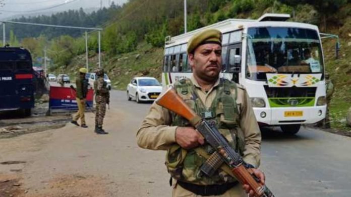A policeman stands guard after tourists were attacked in Pahalgam A policeman stands guard after tourists were attacked in Pahalgam