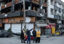 Middle East escalation forces relocation of Indian nationals from Iranian capital People gathered at a corner in Tehran, near a building showing substantial damage.