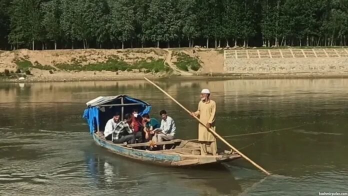 In absence of a bridge, people rely on wooden boats to cross the river In absence of a bridge, people rely on wooden boats to cross the river